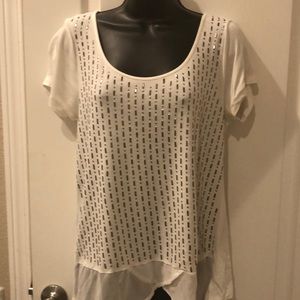 Cream color with silver metallic studs. Short sleeved.